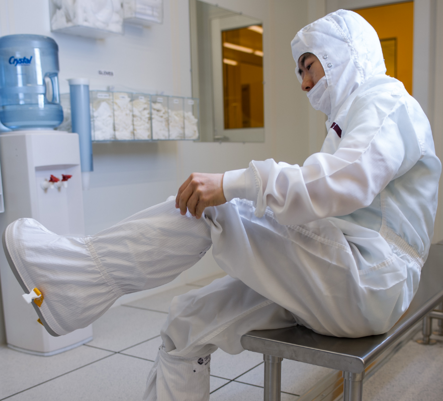 scientist getting dressed into protective suite