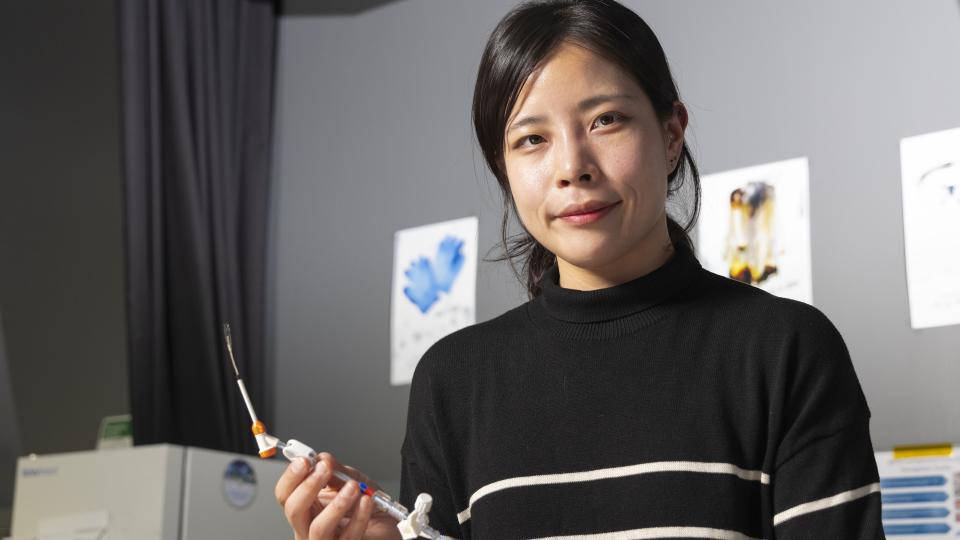 Female researcher in Hong Yeo&#039;s lab holding a nanosensor