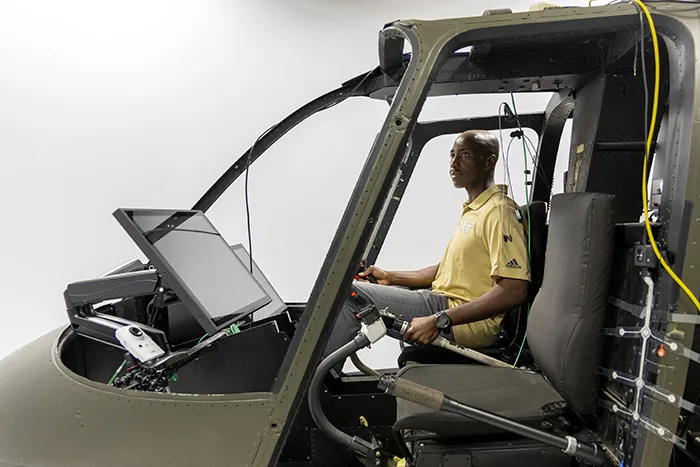 Richard Agbeyibor, Flight Test Engineer, U.S. Air Force, sitting in a space exploration simulator.